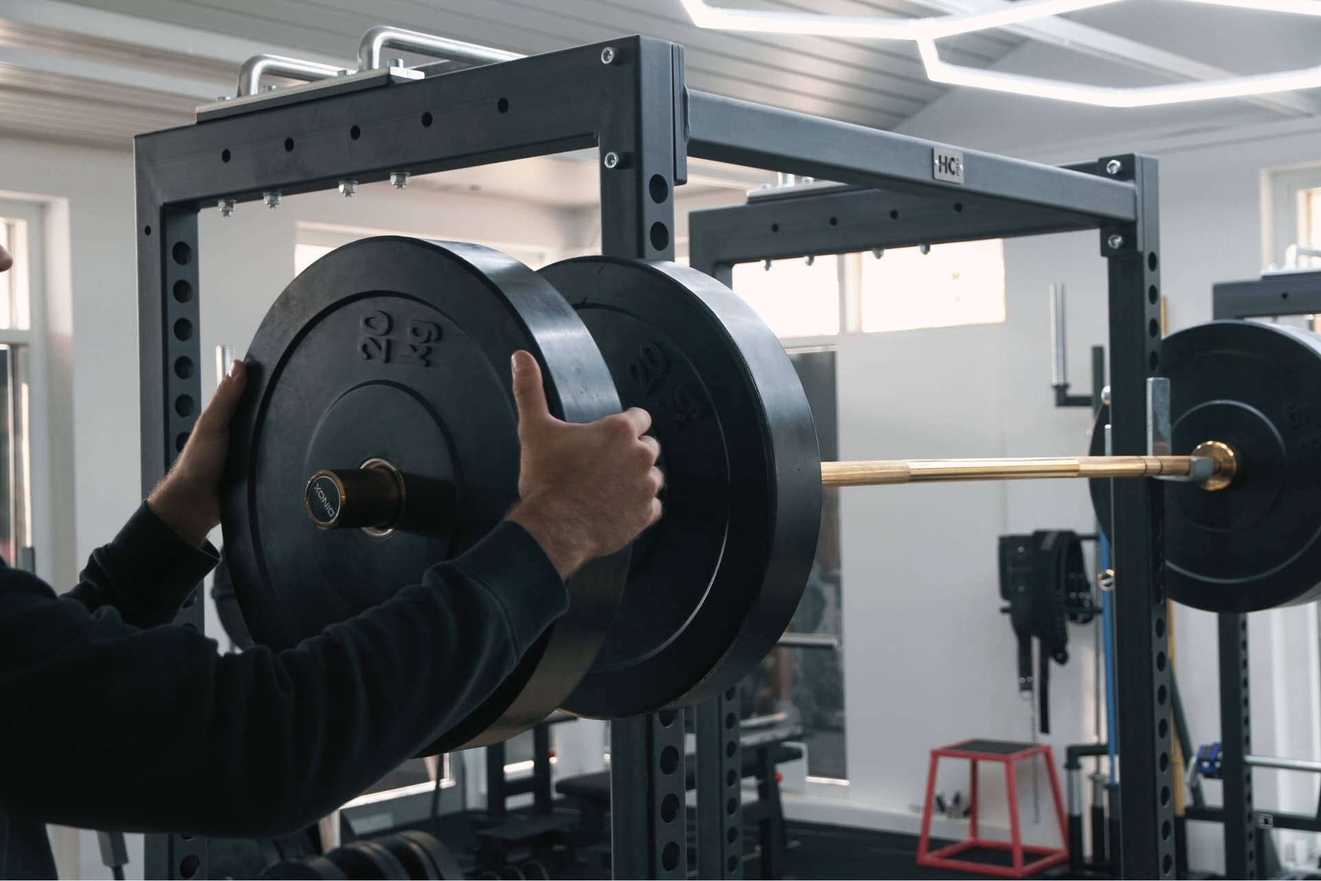A steel power rack set up in a home gym